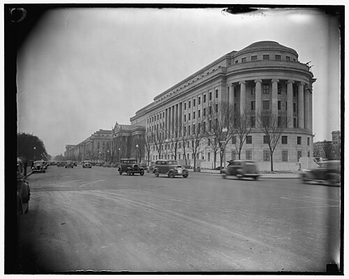 A wide street view of the Federal Trade Commission Building's curved columned corner along Pennsylvania Avenue, taken not long after construction.