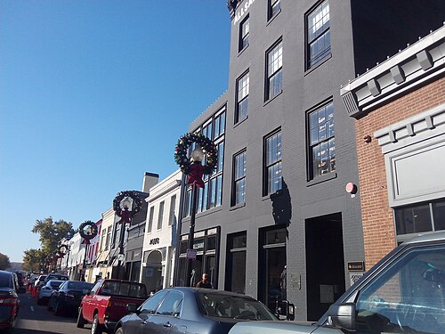 The M Street commercial corridor, storefront row with wreathed lampposts.
