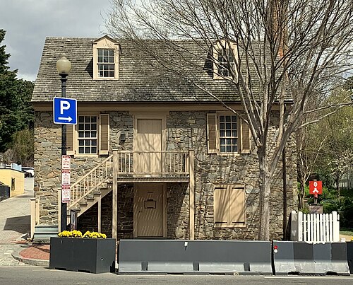 The Old Stone House on M Street, fieldstone facade with tan shutters.