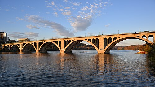 Key Bridge over the Potomac at golden hour from the Georgetown waterfront.