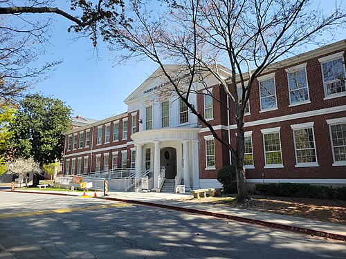 Garden Hills Elementary School, a brick schoolhouse with white columns at the entrance, on a residential street.
