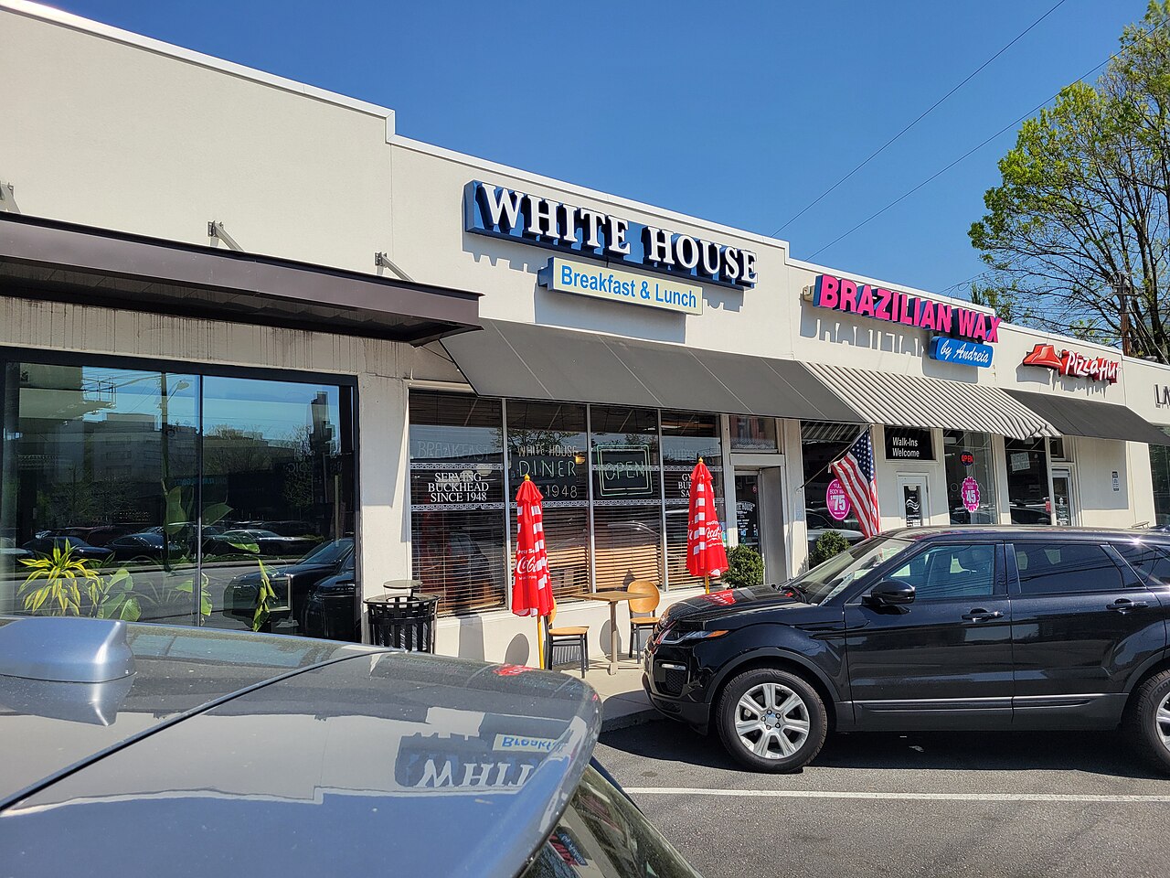 White House Breakfast and Lunch, a diner in a strip of storefronts, with a sign in the window reading Serving Buckhead Since 1948.