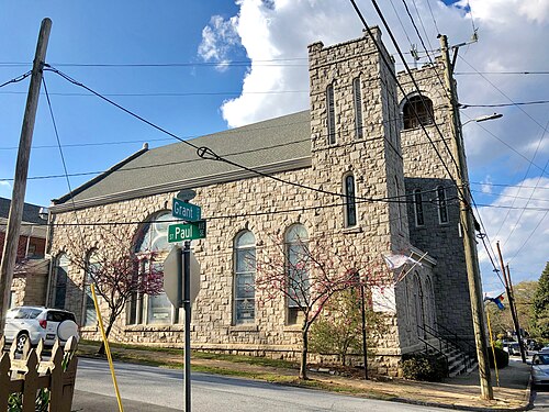 St. Paul United Methodist Church, a stone building with a square corner tower, seen from the corner of Grant Street.