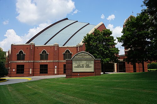 The Horizon Sanctuary, the church Ebenezer Baptist built in 1999 across Auburn Avenue from its old one, red brick under a curved metal roof with a marquee board on the grass.