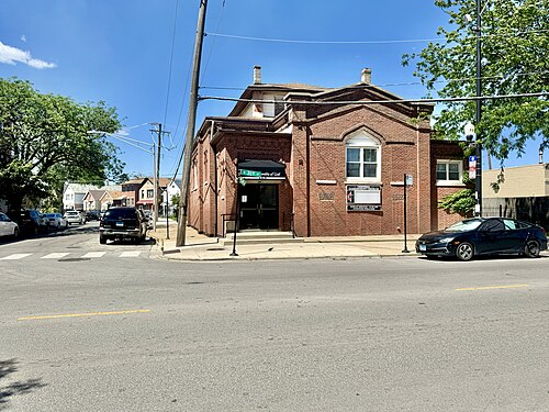 A red brick church at 31st and Poplar, arched windows and a covered entry facing the corner.