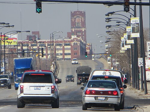 Pershing Road looking toward Union Avenue, a bridge over the rail cut and the old Central Manufacturing District clock tower ahead.