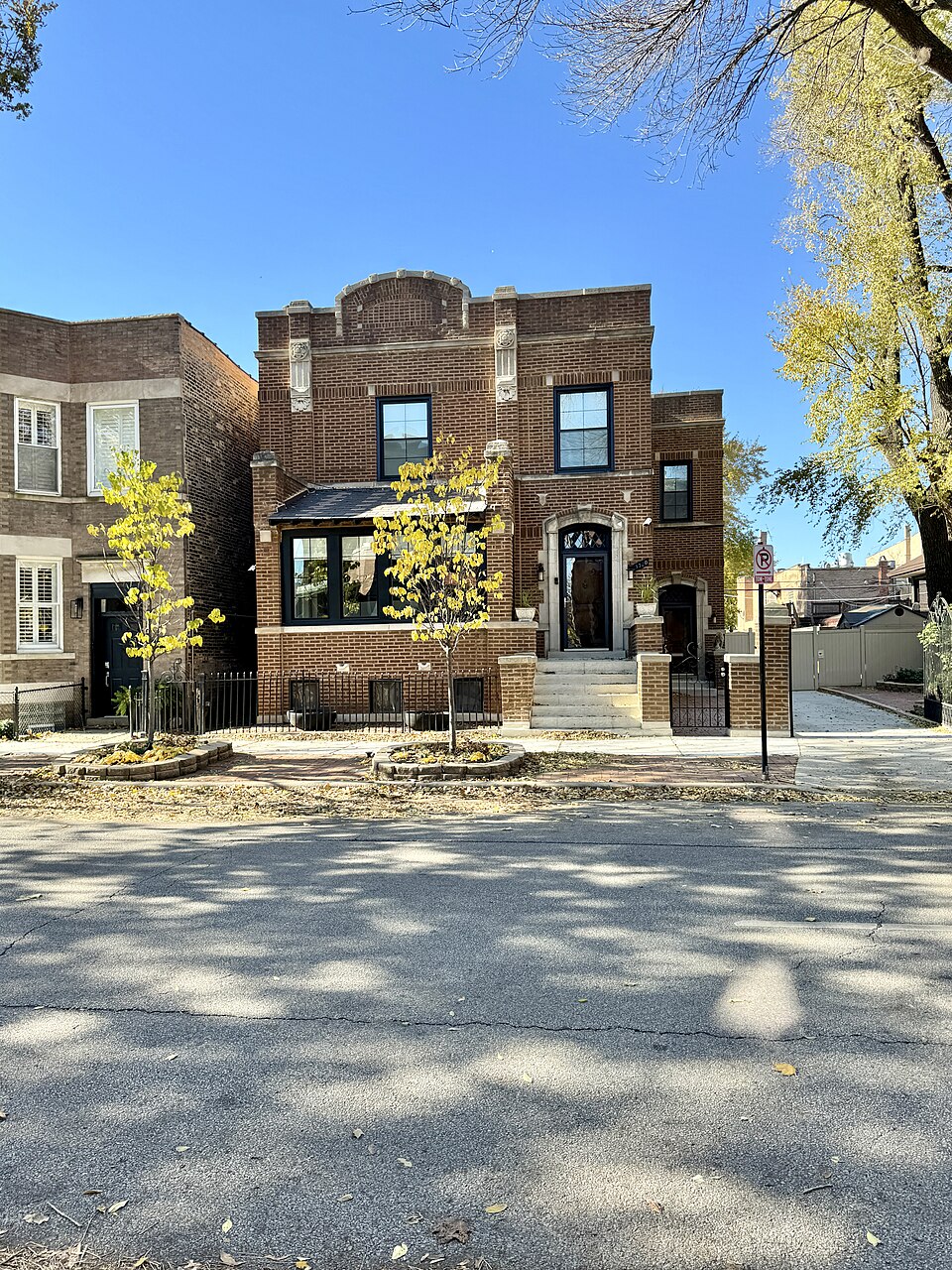A two storey brick building on Emerald Avenue with a stone entrance arch, on the block between 33rd and 34th streets where the production filmed.
