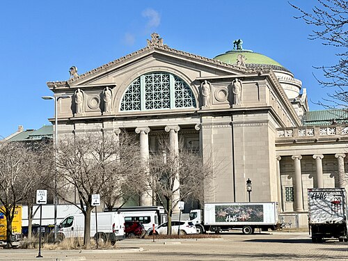 The Museum of Science and Industry's west portico, a Classical Revival stone facade with Ionic columns and a copper dome behind.