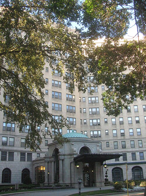The Windermere apartment hotel, a stone facade with a copper domed entrance portico beneath tall bays of windows.
