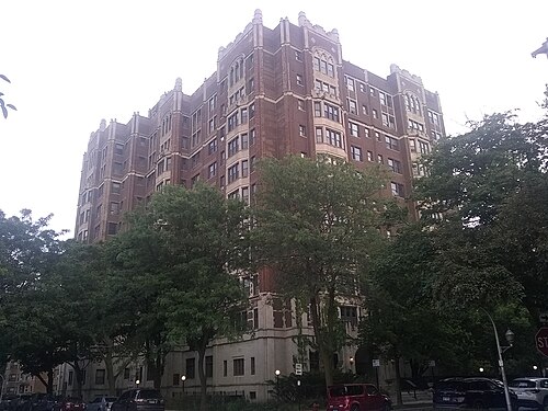 The 6901 Oglesby cooperative, an eleven storey English Gothic apartment tower in brick and limestone, its corners stepped with carved finials.