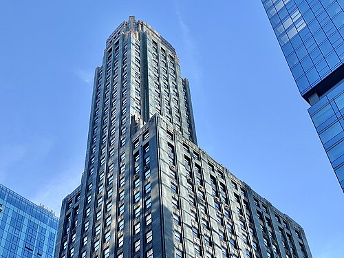 The dark green terra cotta and gold trimmed top of the Carbide and Carbon Building, seen from below against a clear sky.