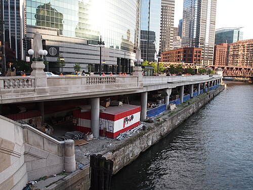 The double decker roadway of Lower Wacker Drive running beneath the office towers along the river.
