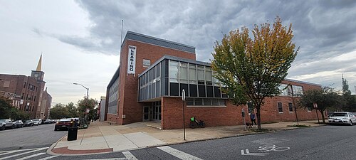 The former St. Brigid's school and convent on South East Avenue, a three storey mid-century building in aluminum and brick with a glass fronted stair tower at the corner.