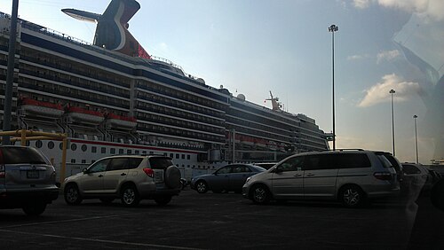 A cruise ship docked beside a parking lot at Locust Point's cruise terminal.