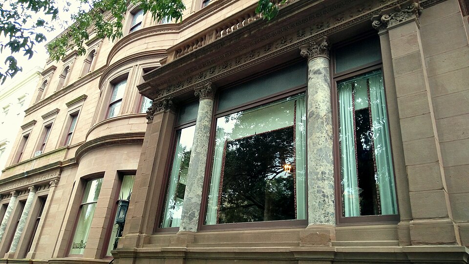 The Garrett-Jacobs Mansion's brownstone and marble facade, engaged columns and carved window surrounds at 11 West Mount Vernon Place.
