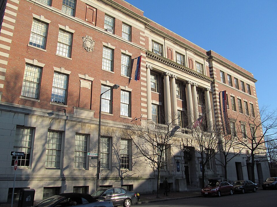 The Benjamin Franklin Institute of Technology's Beaux-Arts building at Berkeley and Appleton Streets, red brick over a stone base, an Ionic columned portico and paired stone-banded piers.