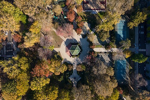 An overhead view of the park's pathway network, the bandstand at the center and sport courts to one side.