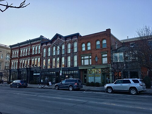 A row of three and four storey brick commercial buildings at Main and Virginia Streets, in a mix of styles.