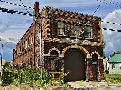 The former Hook and Ladder No. 8 firehouse on Chicago Street, buff brick arches around its garage bay door.