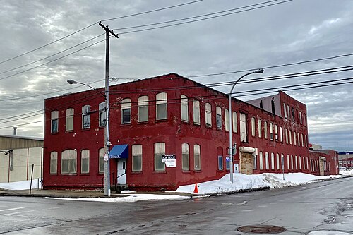 A two storey red brick industrial building at the corner of Chicago and Perry Streets.