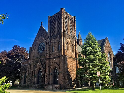 Our Lady of Perpetual Help, a rusticated stone church with a square tower on O'Connell Avenue.