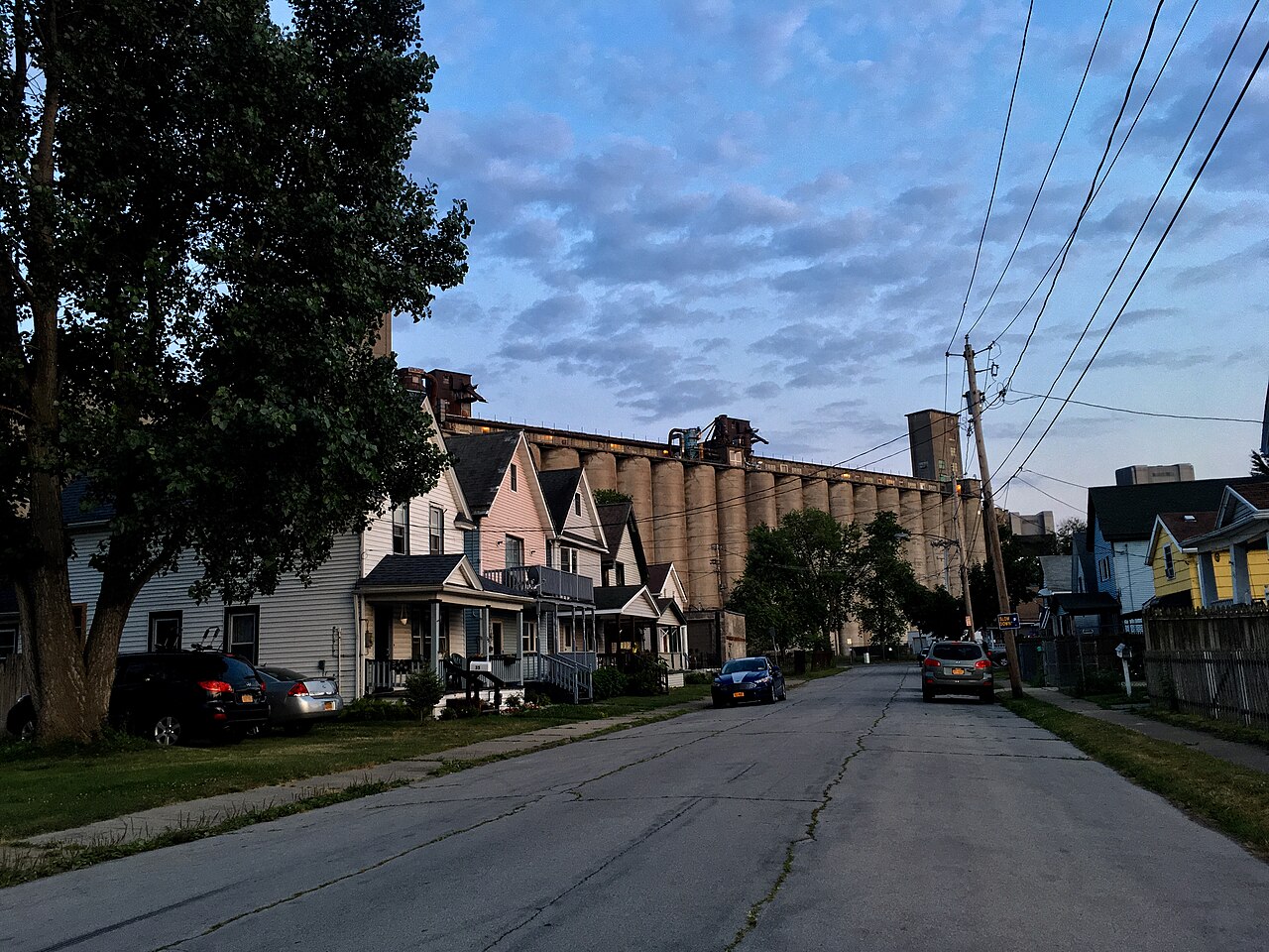 The Standard Elevator looming over a row of small wood frame houses on Kentucky Street.