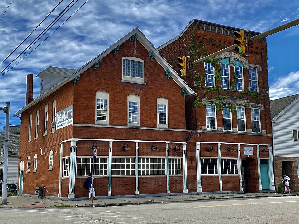 An adjoined Italianate and Romanesque Revival corner storefront at South Park Avenue and Hamburg Street, about 55 m from Adolf's own storefront. The kind of corner tavern block the bar sits on rather than the building itself, which is the Street View beside it.