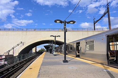 The elevated terminal at Ditmars Boulevard, a train at rest under the Hell Gate viaduct.