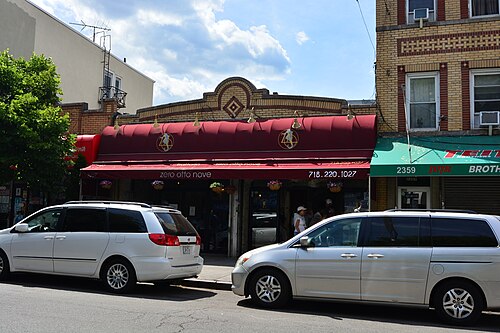Zero Otto Nove at 2357 Arthur Avenue, a dark red awning under a cream brick front with an arched parapet.