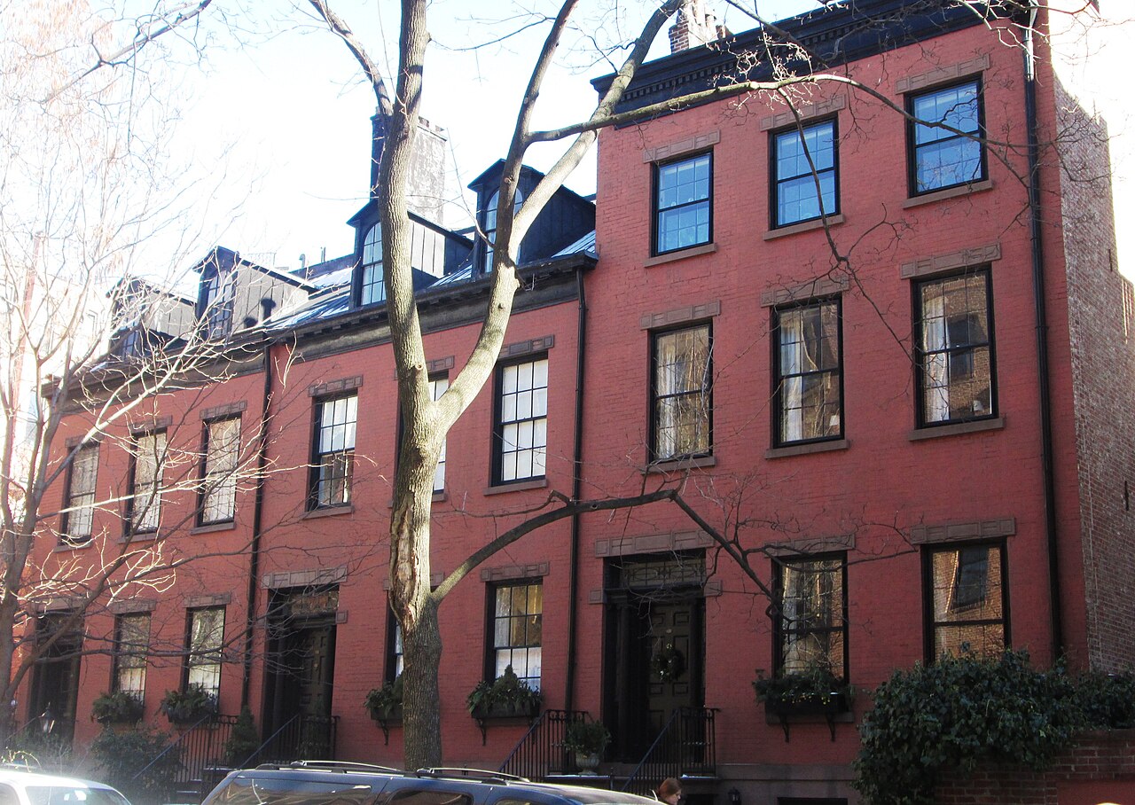 The three Federal houses at 155 to 159 Willow Street, red brick with stone lintels, dormers in a black roof and window boxes at the parlor floor.