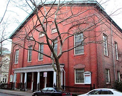 Plymouth Church on Orange Street, a plain red brick meeting house with a white portico along the front and tall arched windows.