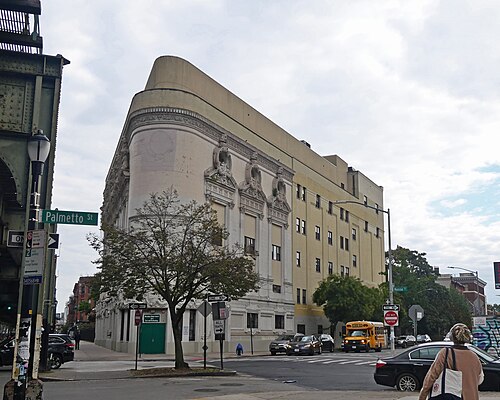 The side of the former RKO Bushwick theatre building, looking southeast on a cloudy midday.