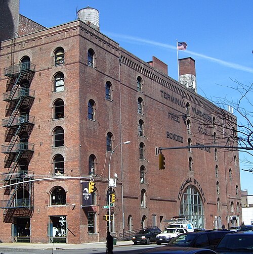 The Terminal Warehouse building on Eleventh Avenue, red brick with arched windows and TERMINAL WAREHOUSE painted across the upper wall.