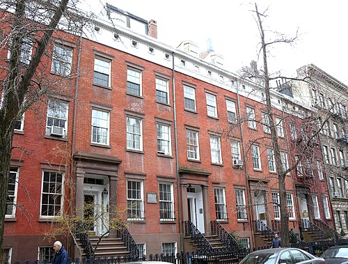 Cushman Row on West 20th Street, red brick houses with brownstone doorways, stoops and iron rails, set back behind small front yards.