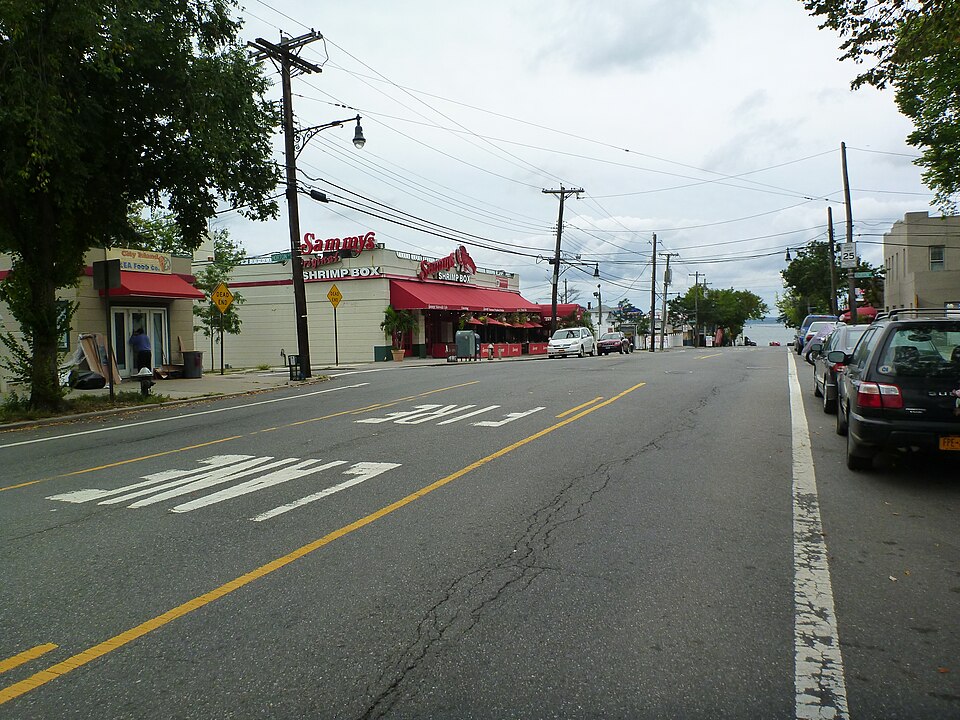 City Island Avenue looking south near the end of the island, seafood restaurants along the left and the water where the street runs out.