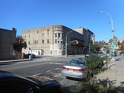 The former Loew's theatre on the corner of Bergen Street and Bedford Avenue at Grant Square, now a church, with a vertical TEMPLE sign on the rounded corner bay.