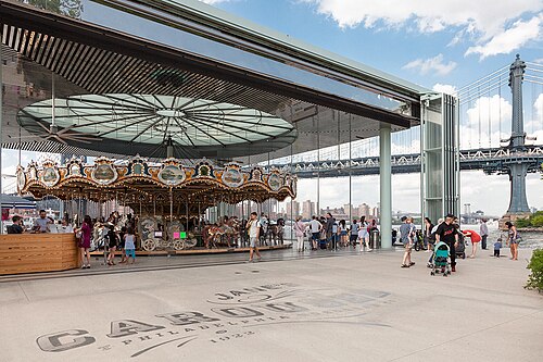 Jane's Carousel in its glass pavilion, the bridge tower behind.