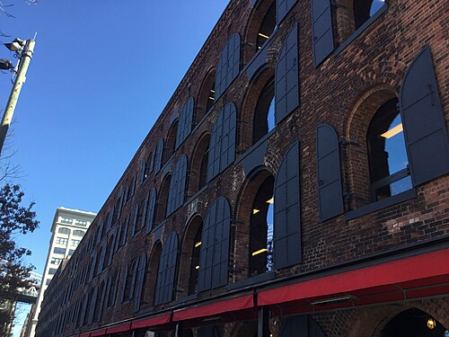 Empire Stores' tiers of brick arches with iron shutters swung open.