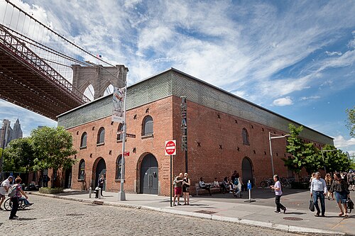 St Ann's Warehouse from the cobbled Water Street corner under the Brooklyn Bridge roadway.