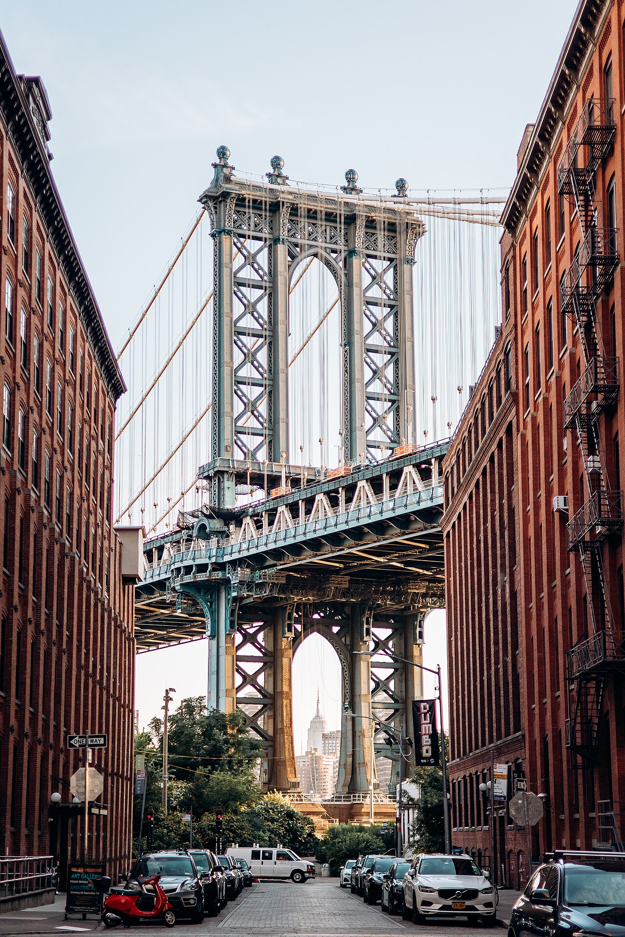 The Washington Street view, brick warehouses either side, the Manhattan Bridge tower with the Empire State Building through the lower arch.
