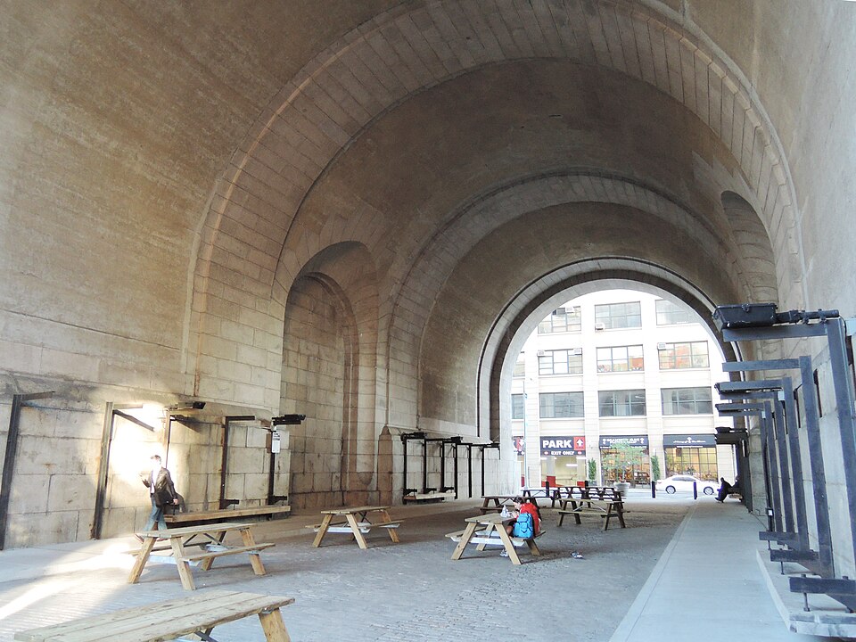 Inside the DUMBO Archway, the granite barrel vault under the Manhattan Bridge anchorage at Water Street.