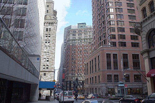 William Street at Cedar Street, a Chase entrance under a glass canopy on the left and a stone tower with a battlemented top beyond it.