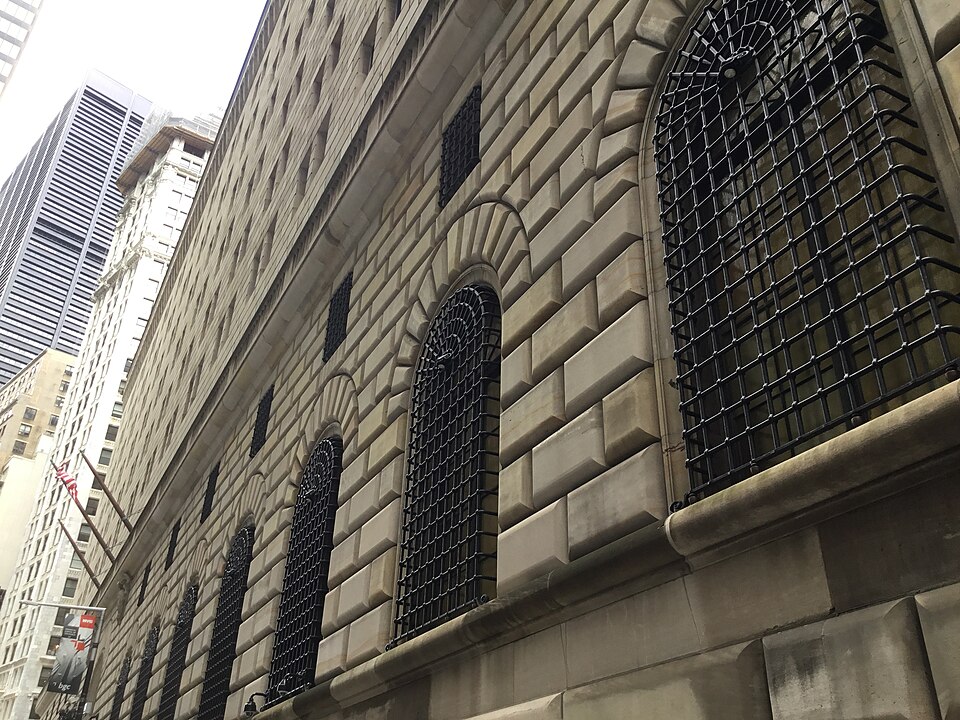 The Federal Reserve on Liberty Street, deeply rusticated stone with iron grilles over the arched windows.