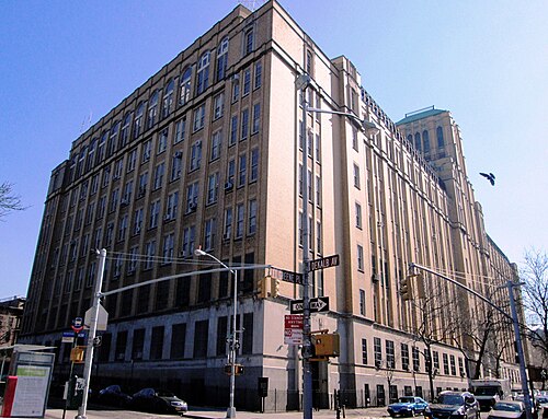 Brooklyn Technical High School at DeKalb Avenue and Fort Greene Place, eight storeys of brick and limestone filling the corner.