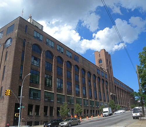 The American Bank Note Company's factory at Tiffany Street and Lafayette Avenue, arched windows down a full block and a corner tower.