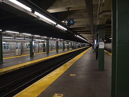The underground platform at the Hunts Point Avenue subway station, a train stopped across the tracks.