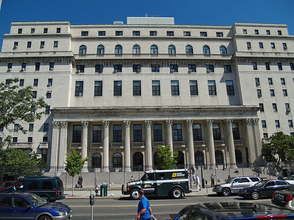 The Queens County Courthouse on Sutphin Boulevard, its Corinthian colonnade and rows of upper story windows seen from across the street.