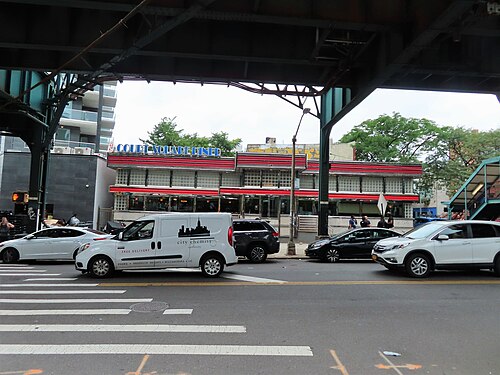 The Court Square Diner at 23rd Street, chrome and red under the green steel of the elevated 7.