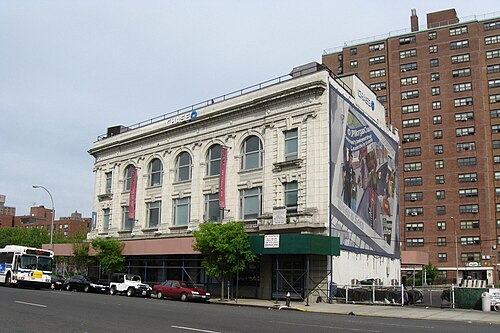 The former North Side Board of Trade building on Third Avenue at East 137th Street, white terra cotta with round arched windows, later a savings bank.