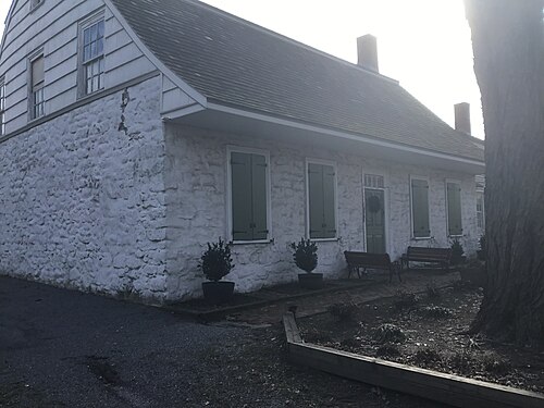 The Vander Ende-Onderdonk House, a whitewashed fieldstone Dutch colonial farmhouse.